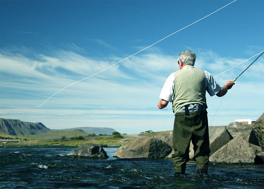 senior man fly fishing
