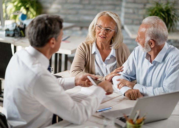 couple discuss estate plan with financial advisor