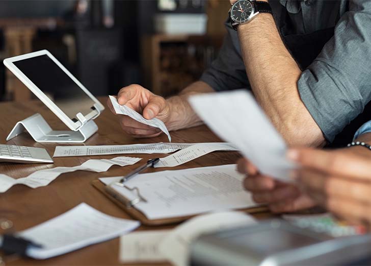 an accountant helping a small business owner go through their transactions
