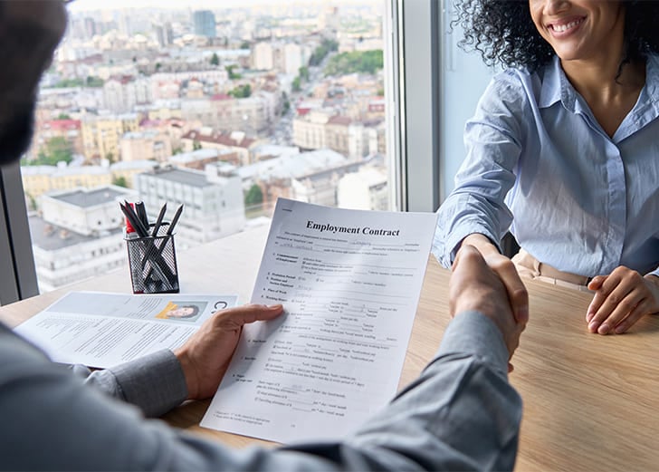 an employer and new employee shaking hands