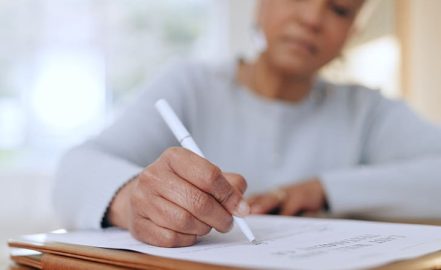 a woman signing a DAPT document
