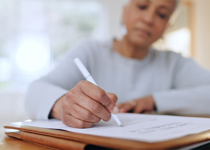 a woman signing a DAPT document