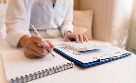a CPA writing in a notebook