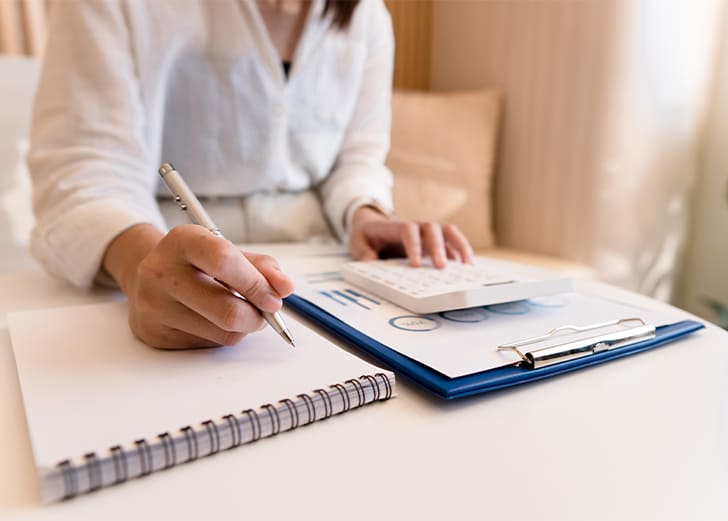 a CPA writing in a notebook