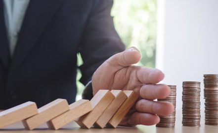 A hand protecting assets from blocks