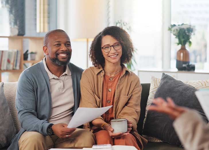 a young couple discussing life insurance with a financial advisor